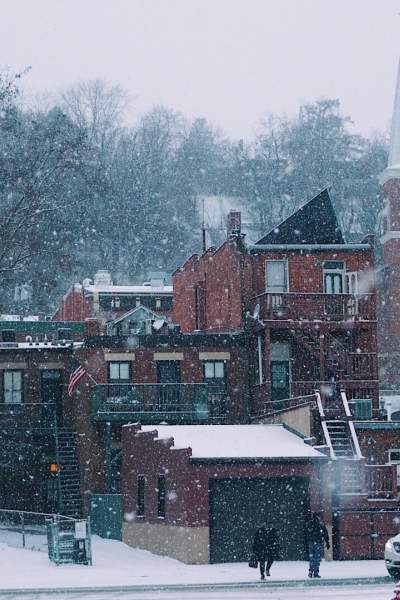 Snow falling on buildings 
