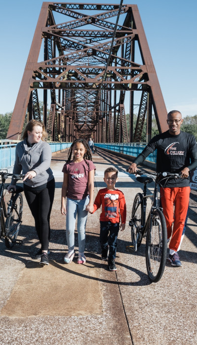 Family with bikes on a bridge