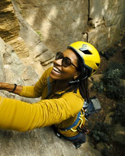 A climber hangs from a rockface