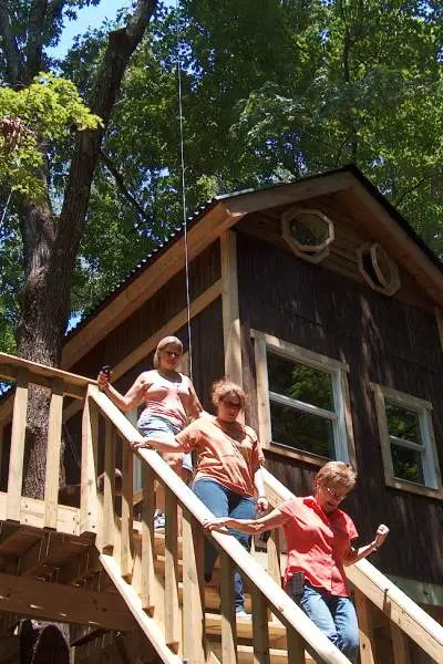 A cabin house with woman walking down the stairs