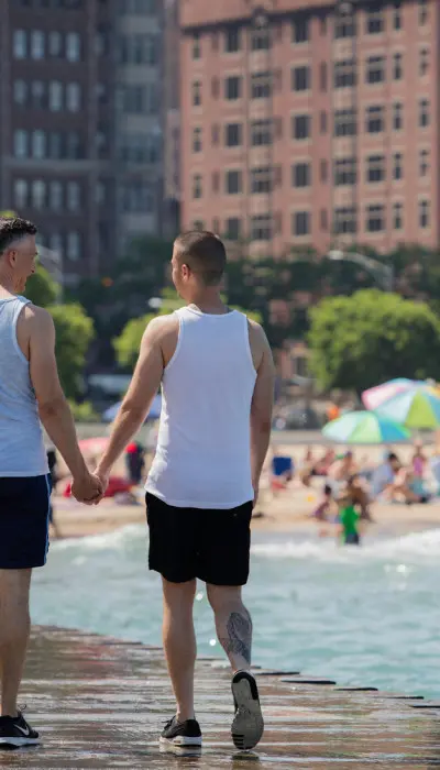 Same sex couple walking down Lake Mil Park.