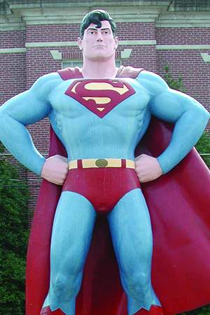 a statue of Superman outside a building