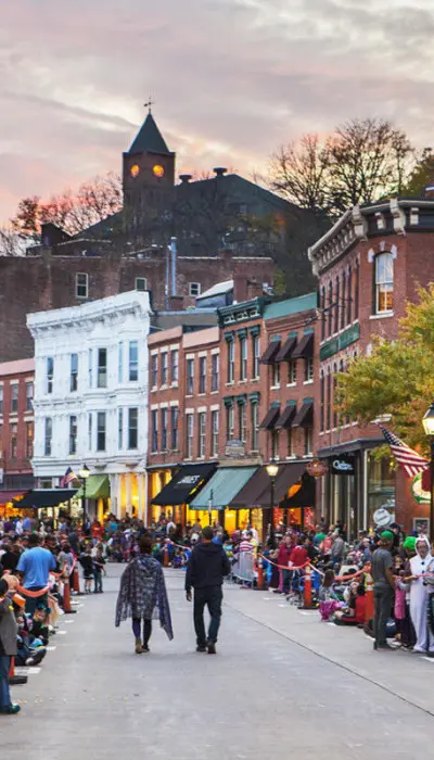 Main street of Galena filled with people in halloween costumes.