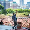 Singer performing for thousands of people at Lollapalooza