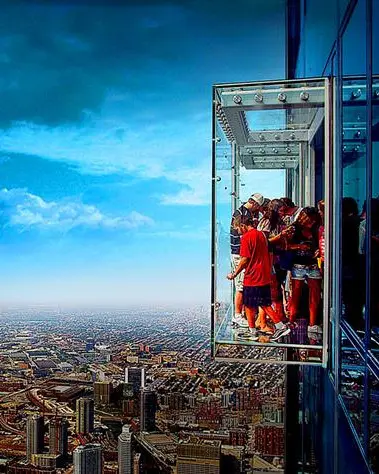 People on the skydeck looking down at the buildings below