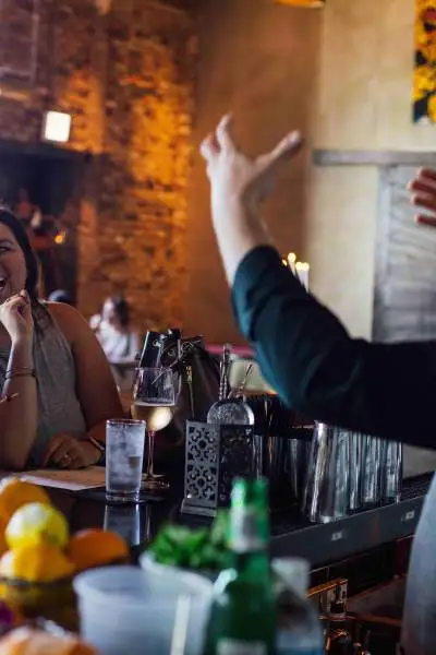 Bartender entertaining customers. 