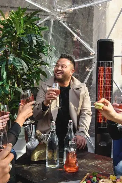 Group of friends drinking wine and talking to each other.