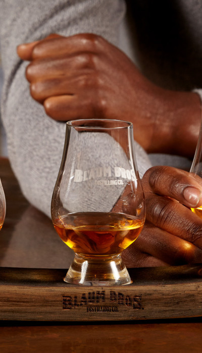 Three whiskey glasses with Blaum Bros branding.