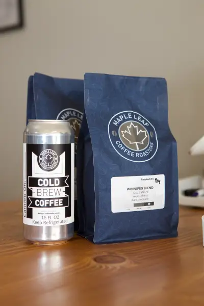 Can of cold brew coffee next to coffee bags