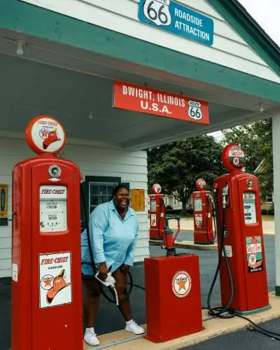 A woman holds a gas pump