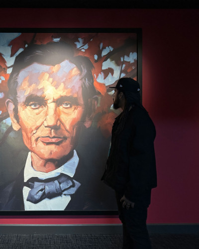 Dilla in front of a painting at the Abraham Lincoln Presidential Library and Museum