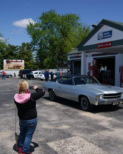 People taking photos of a historic gas station