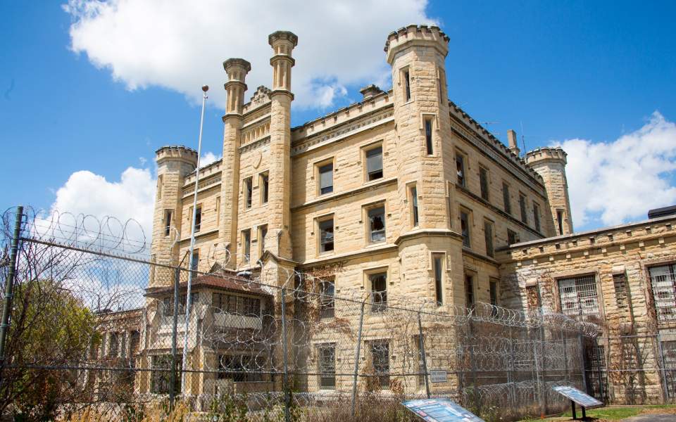 A large building with a barbed fence