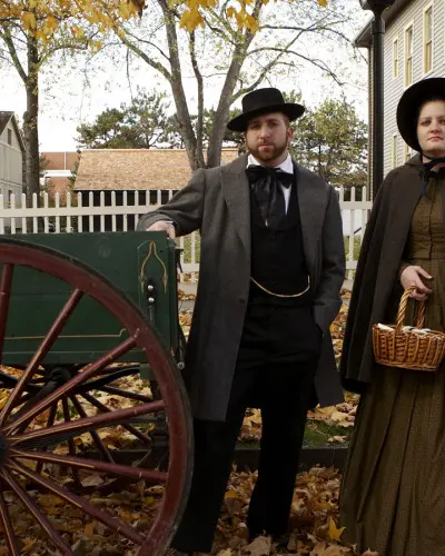 Actors stand by an old vehicle at the Lincoln Home