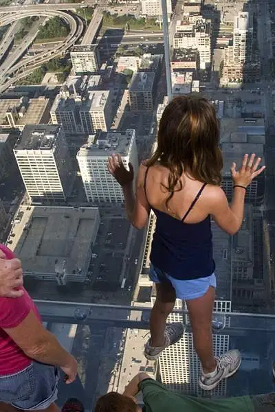 People looking down at building below