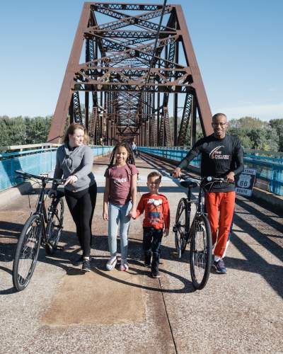 Family with bikes on a bridge