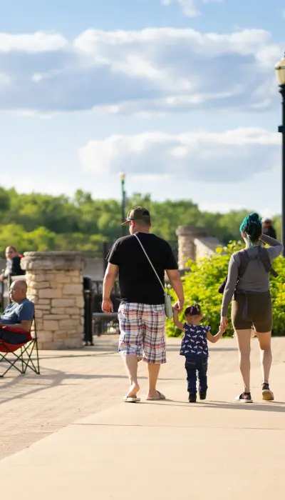 Family outside walking on a sunny day.