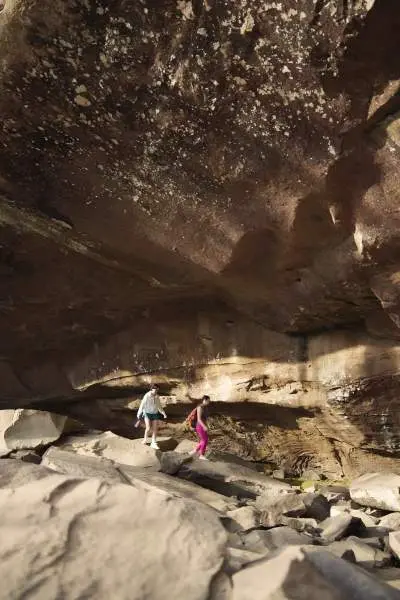 People walk in a rocky cave