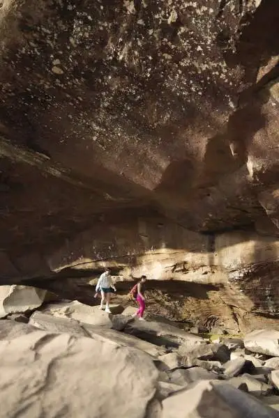 People walk in a rocky cave