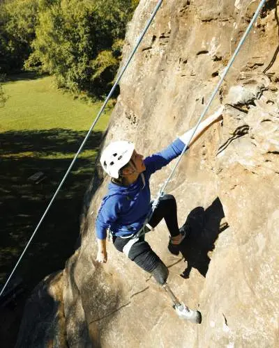 A climber hands from a rock in Giant City State Park