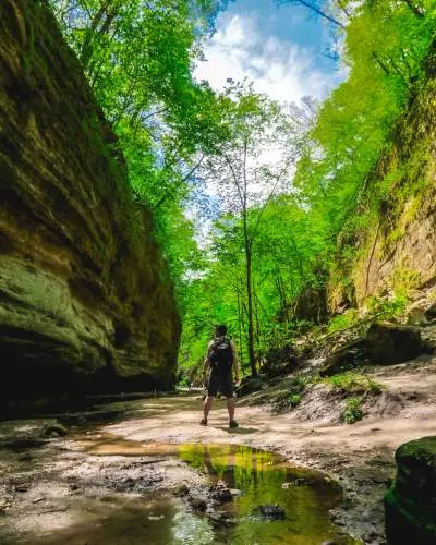 A man stands between two rockfaces 