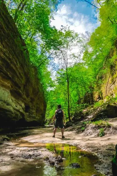 A man stands between two rockfaces 