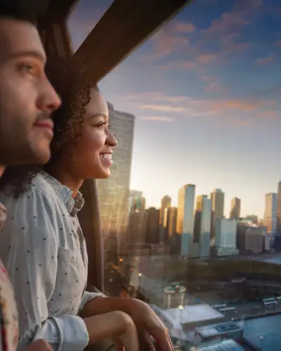 A couple look at the window of the Centennial Wheel