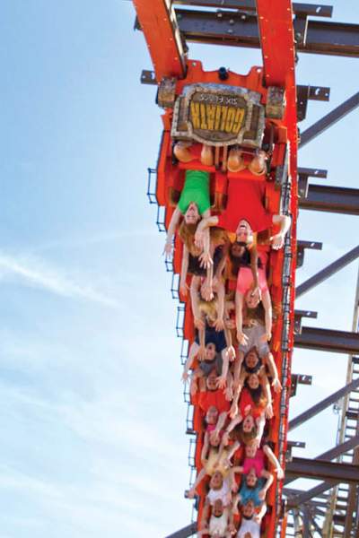 A red roller coaster full of people