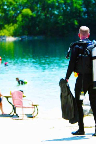 Scuba divers walking to the beautiful waters of Haigh Quarry in Kankakee