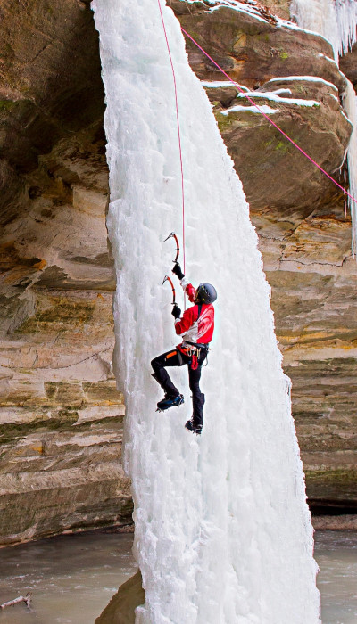 Person climbing ice waterfall