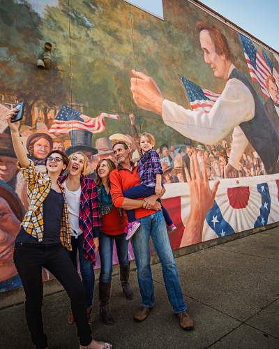 Family taking a selfie in front of a Mural in Ottawa