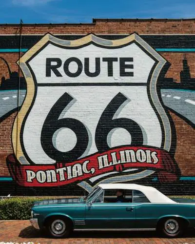 Route 66 Mural with a Pontiac car in front.