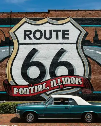 Route 66 Mural with a Pontiac car in front.