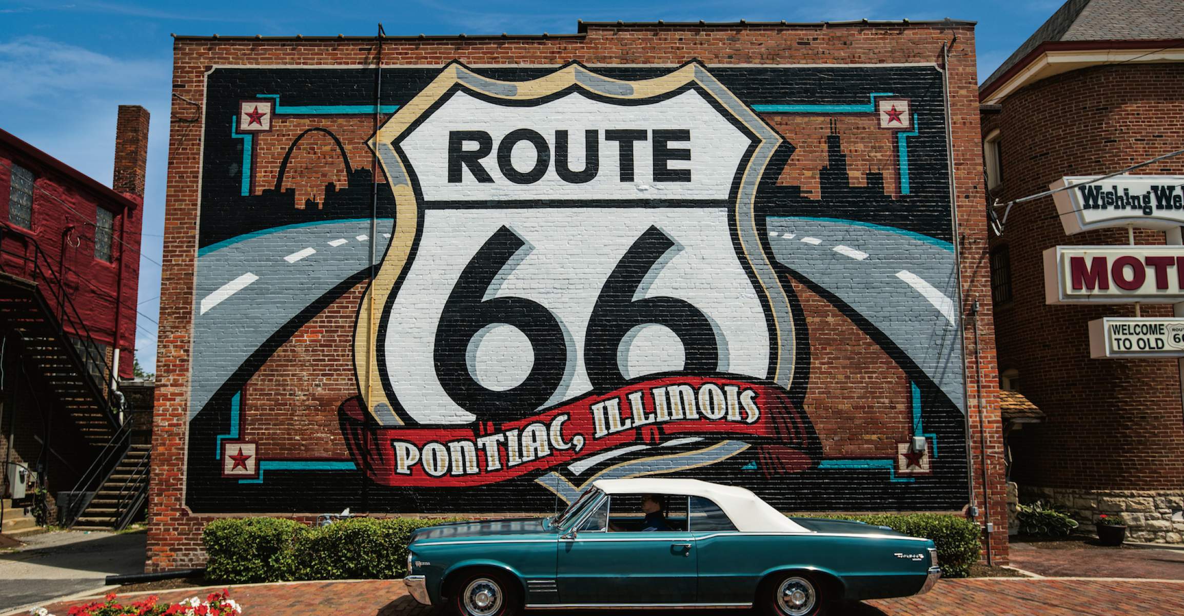 Route 66 Mural with a Pontiac car in front.