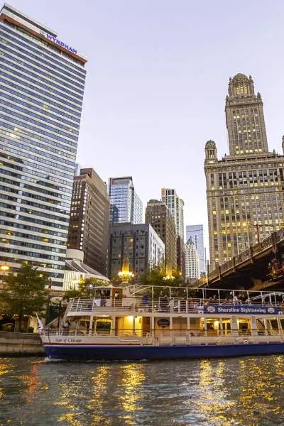 A boat on the water with the big city buildings behind it