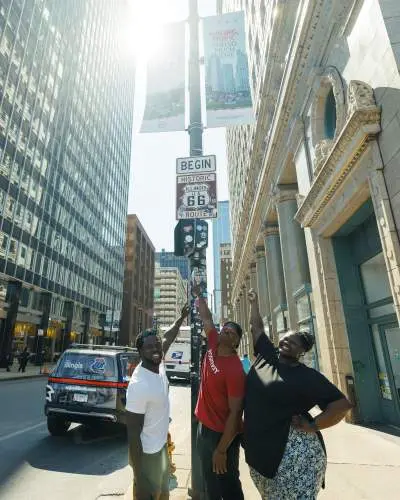 Visitors point at the Route 66 sign in Chicago