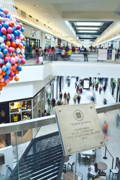 A view of stores and shoppers from an upper level of Fashion Outlets of Chicago