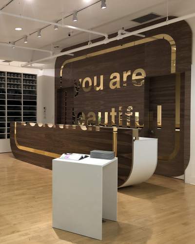 The interior of a shop with a large "You Are Beautiful" sign