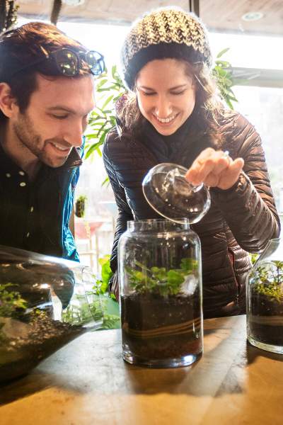 A couple looking at planted terrariums at Sprout Home in Chicago