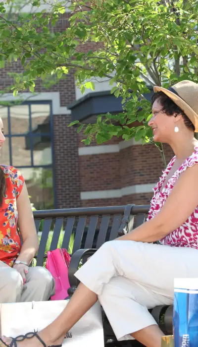 Two ladies sitting down together