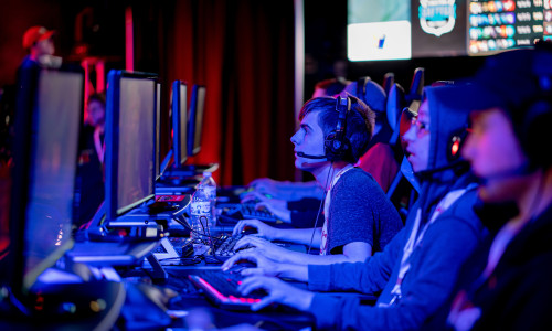 People on Computers competing in an esports tournament