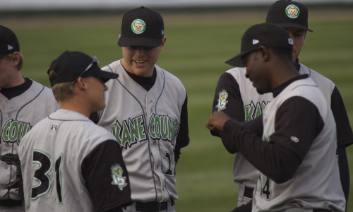 Players talk strategy at a Kane County Cougars game